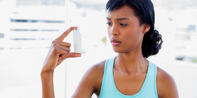 A woman wondering about her asthma inhaler