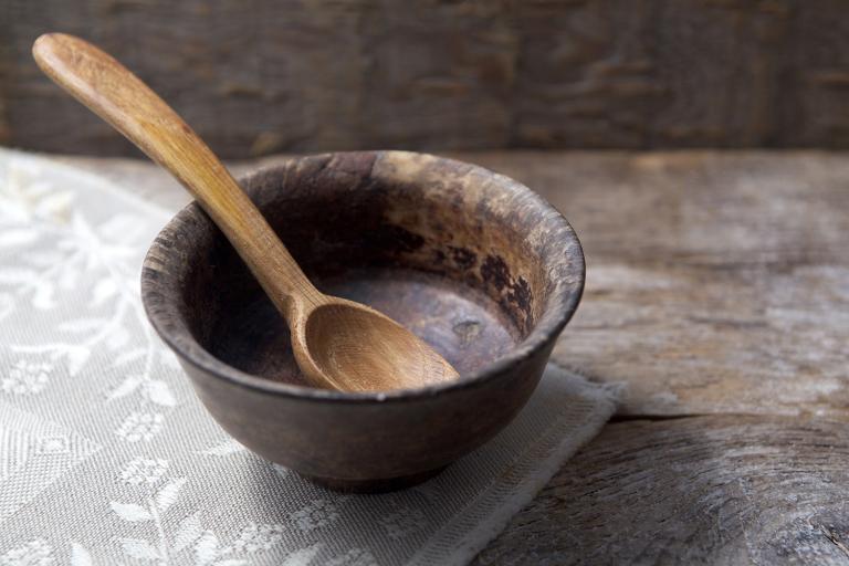 An empty bowl with a wooden spoon