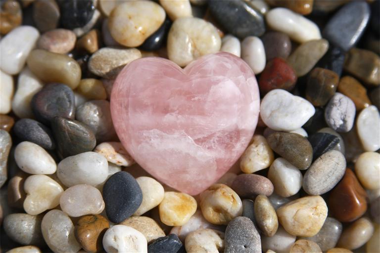 a pebble rock garden with a rose quartz heart